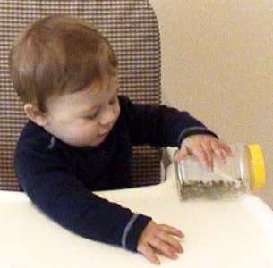 W 8m knocks jar off table.jpg