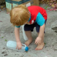Toddler bend forwards to reach ground in a half squat