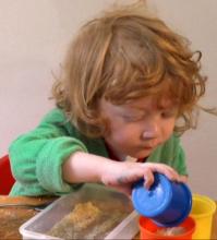 Toddler reaching across the midline