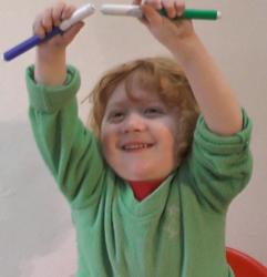 Toddler with good core stability reaching up above the head